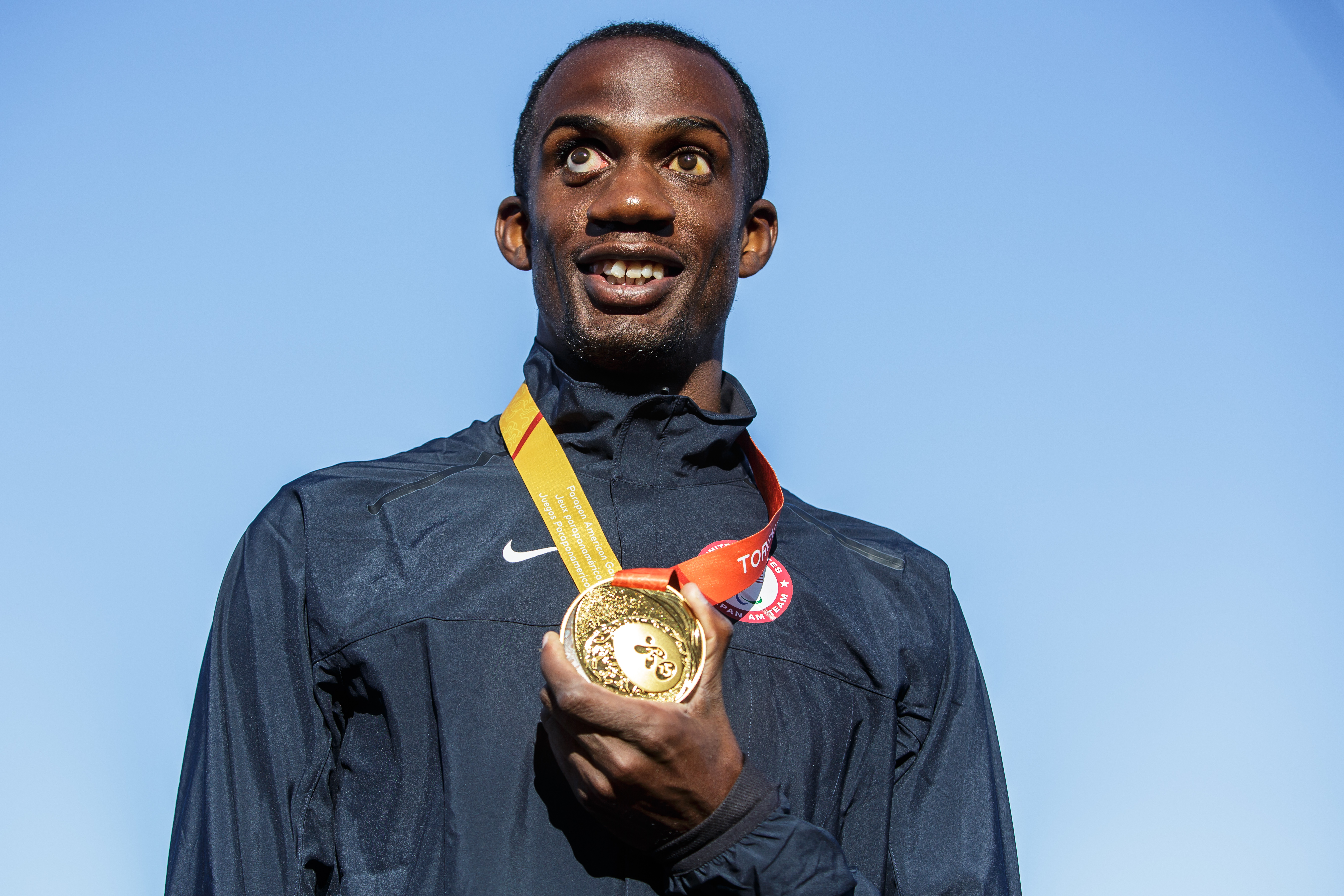 Lex Gillette wearing his Paralympic Medal